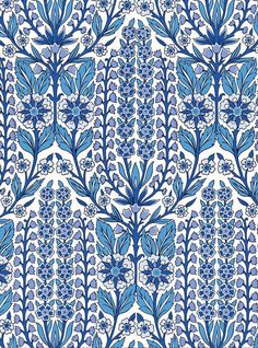 a blue and white wallpaper with flowers on the bottom, in an ornate pattern