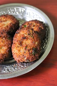 three fried food items on a metal plate