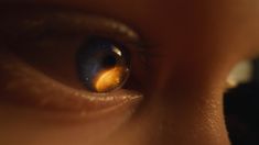 a close up view of the iris of a person's eye with an orange spot in it