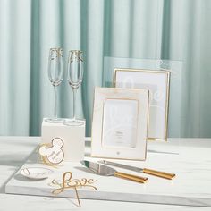 a table topped with wine glasses and personalized items