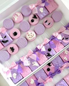 purple and pink desserts are arranged on display