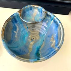 a blue bowl sitting on top of a counter