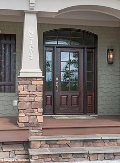 the front entrance to a house with two doors and steps leading up to it's entry