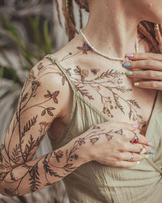 a woman with tattoos on her arms and chest