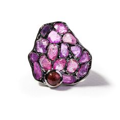 In a world where jewelry is often a symphony of uniformity, exists a singular designer ring that defies convention. Crafted using the innovative German Kabirski method of raw gemstone setting we call 'stained glass', it cradles raw pink spinel in a creative mosaic. Polished pink tourmaline dots on the side add an irresistible contrast. This ring isn't just jewelry; it's nature's energy captured, waiting for that one special person it's meant to adorn – as a personal connection to Earth's untouched beauty. Metal: 925 Silver Stones: Ruby Rough, Pink Sapphire Plating: Black Rhodium  German Kabirski loves pairing gemstones, playing with contrasting colors, textures, and cuts to create harmonious asymmetry. You can be sure that all our gemstones are of natural origin, sourced ethically and resp