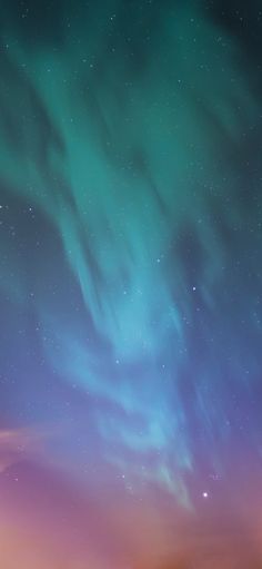 the sky is filled with bright green and blue aurora lights, as well as stars