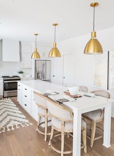 the kitchen is clean and ready for us to eat dinner in it's white cabinetry