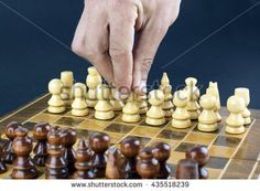 a man playing chess with his hand on the queen's board and other pieces