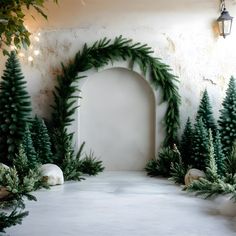 a white arch surrounded by evergreen trees and other greenery