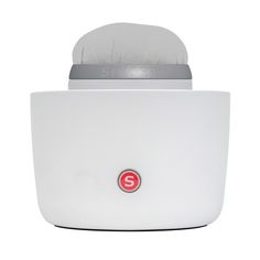 a white object with a red button on the front and side of it's body