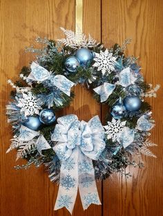 a christmas wreath with blue and white decorations