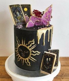 a black and gold cake with pictures on it