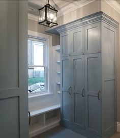 an empty room with a window and some cupboards