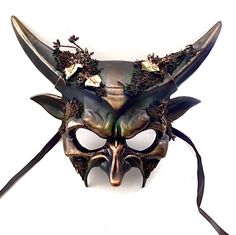 Step into the mystical embrace of the forest with our captivating masquerade mask. The horned elements add an air of mystery and majesty, creating a unique and captivating look. From masquerade balls to extravaganzas and special celebrations, our forest mask will catch attention!


Age Group/Gender - Adult/Mens

Size/Type - One size fits all adults

Mask Color - Forest green/gold accents

Mask Material - Polyresin

Accent Material - Paint

Special Features - Foliage Fantasy Masks And Prosthetics For Carnival, Gothic Eye Mask For Fantasy Events, Gothic Horned Masks For Fantasy Events, Fantasy Masquerade Mask For Carnival Festival, Fantasy Style Masquerade Mask For Carnival Festival, Gothic Masks For Halloween Fantasy Events, Gothic Masks For Halloween, Fantasy Masks For Carnival And Festivals, Fantasy Masks And Prosthetics For Carnival And Halloween