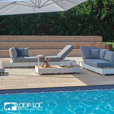 an outdoor lounge set next to a swimming pool