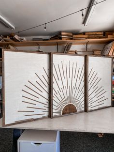 an office cubicle with three partitions on the wall and shelves in the background