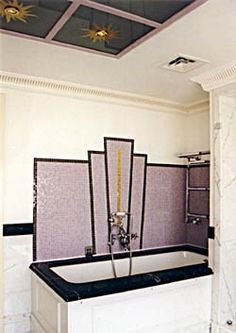 a bath tub sitting inside of a bathroom next to a shower head mounted on the side of a wall