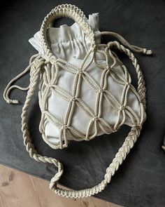 a white bag sitting on top of a wooden floor