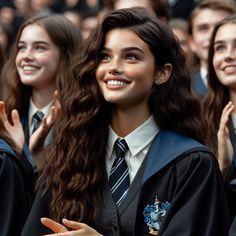 a group of young women standing next to each other in front of a large crowd