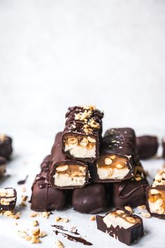 several pieces of chocolate with nuts on top