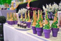 there are many cupcakes decorated like trees on the table