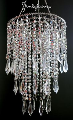 a chandelier hanging from the ceiling with crystal drops on it's sides