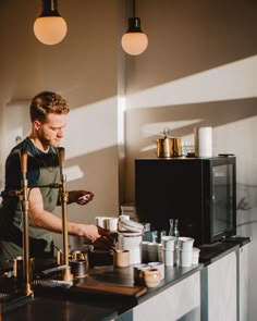 a man standing in front of a coffee machine