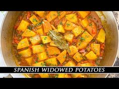 a pan filled with stew and potatoes on top of a table