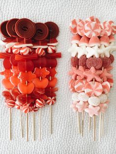 two rows of lollipops with bows and hearts on them sitting next to each other