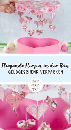 a pink box with hearts hanging from it and the words, valentine's day in german