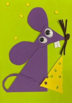 a paper mouse holding a piece of cheese on top of it's head with eyes