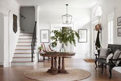 a living room filled with furniture and a staircase