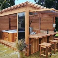 a wooden hot tub sitting next to a picnic table