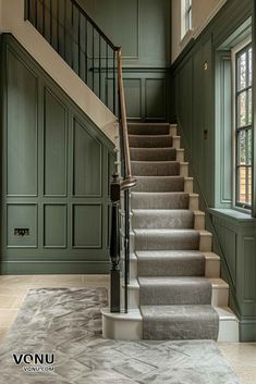 a staircase with carpeted steps and green walls