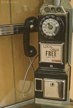 an old fashioned pay phone sitting on top of a counter