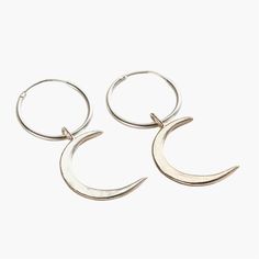 These lunar-inspired Crescent Moon Charm Hoop Earrings add a touch of celestial beauty suitable for both everyday and occasional wear. The crescent shapes evoke mystical and romantic associations often linked with the moon, such as cycles, intuition, and feminine energy. Handmade by our jewellers in Sterling Silver. We make our jewellery using the finest quality 925 Sterling Silver. Half Moon Earrings With Moon Charm, Metal Half Moon Earrings With Moon Charm, Half Moon Metal Earrings With Moon Charm, Half-moon Metal Earrings With Moon Charm, Metal Moon Shaped Hoop Earrings, Metal Crescent Hoop Earrings, Celestial Hoop Sterling Silver Earrings, Sterling Silver Celestial Hoop Earrings, Metal Moon-shaped Hoop Earrings