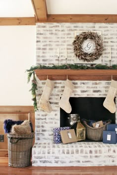 a fireplace decorated for christmas with stockings and stocking