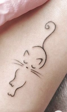 a small cat tattoo on the right arm and leg, it looks like an animal