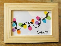 a wooden frame with a string of lights on the front and bottom that says rowan 2011