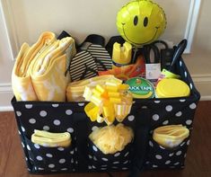 a black and white polka dot basket filled with yellow items on top of a hard wood floor