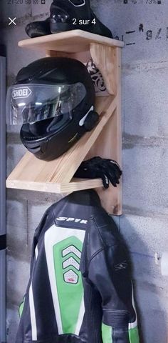 two motorcycle helmets are sitting on wooden shelves