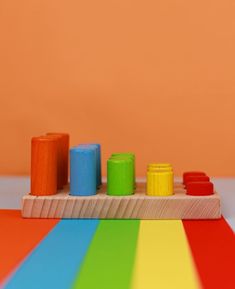 a wooden toy with different colored blocks on it