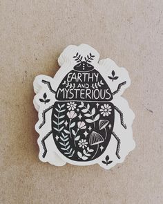 a sticker with the words earth and mysterious written in black on it's side