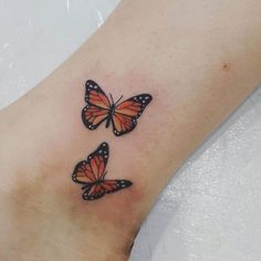 three orange butterflies on the ankle