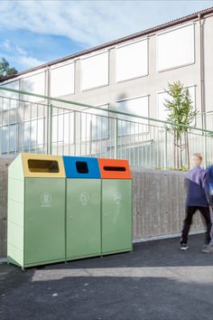 a group of trash cans sitting in front of a building