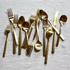 a group of gold colored forks and spoons