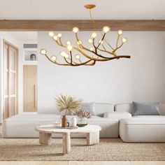 a living room with white couches and a chandelier hanging from the ceiling