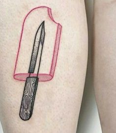 a tattoo on the leg of a woman with a knife in it's blade