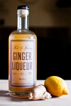 a bottle of ginger liquor next to a lemon