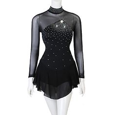 a mannequin wearing a black dress with silver beads on the neck and sleeves